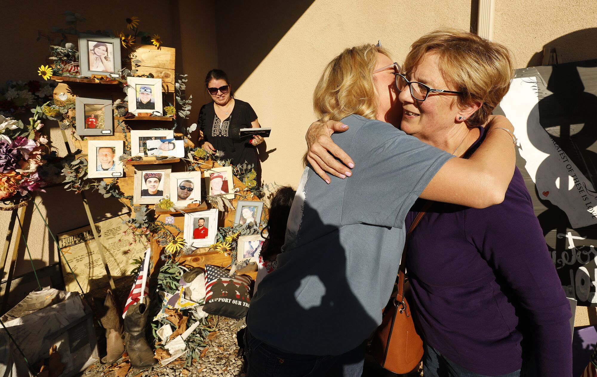 Kathy Dunham, left, Mother of Jake Dunham, 21, hugs Elsa Manrique, right, Mother of Dan Manrique, 33, both who were among those killed in the mass shooting at the Borderline Bar & Grill in Thousand Oaks. They visited at the memorial to the 12 victims that stands in front of the country-western bar frequented by college students as the one year anniversary of the shooting on Nov 7, 2018 draws near.