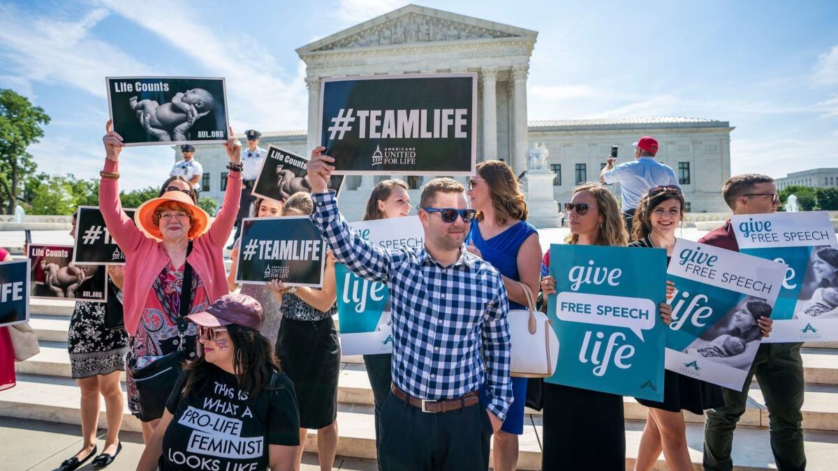 Antiabortion activists gather outside the Supreme Court on June 26.