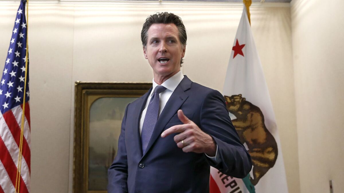 Gov. Gavin Newsom discusses his decision to fire state Oil and Gas Supervisor Ken Harris while talking with reporters at his office in Sacramento on Friday.