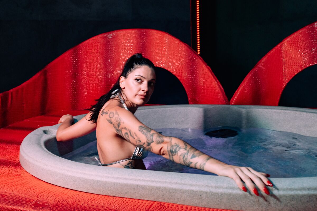 A woman is sitting in a hot tub. 