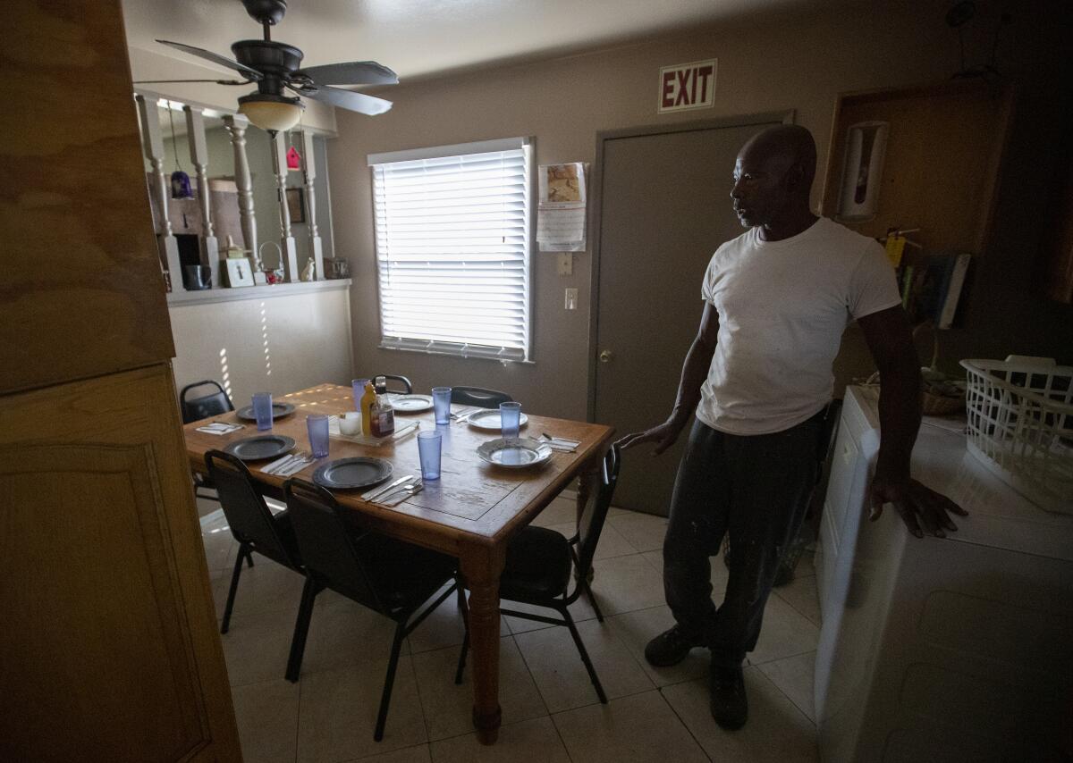 Sam Blake stands in the kitchen of the Blake Home in Sylmar. He runs the board-and-care facility with his mother and sister.