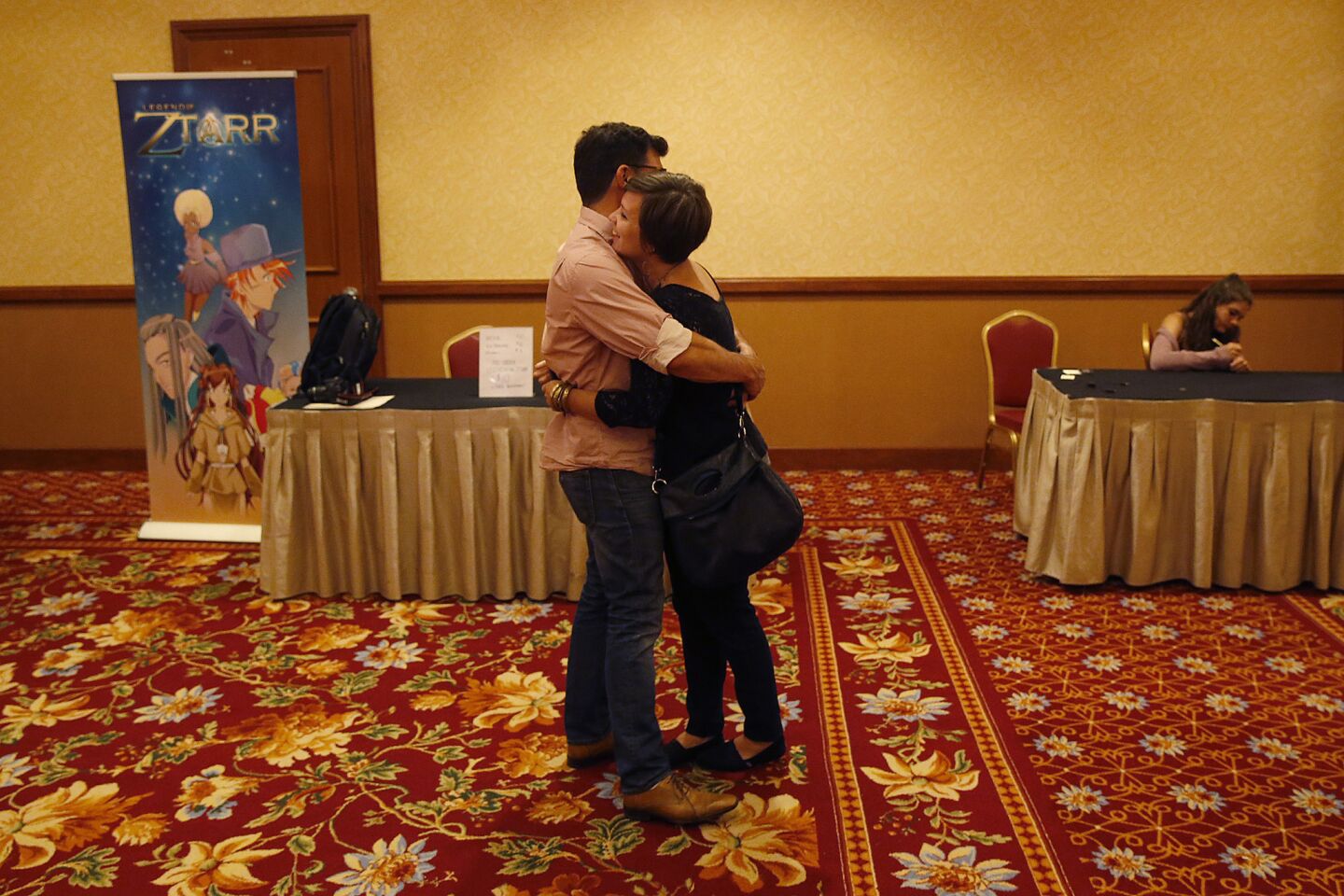 Ryan Bell hugs his girlfriend Rebecca Pratt at the conference of atheists, skeptics and freethinkers in Las Vegas. Pratt is open-minded and unafraid to stop Bell when he lapses into negative generalizations about religion.