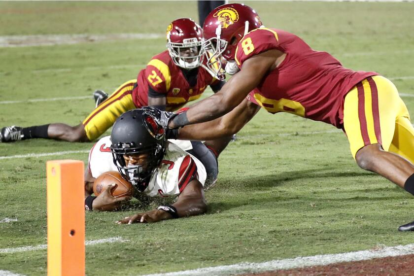 USC's Ajene Harris #27, and Iman Marshall #8, stop Utah running back Troy Williams short of the goal line on the two-point play which preserve the USC victory.