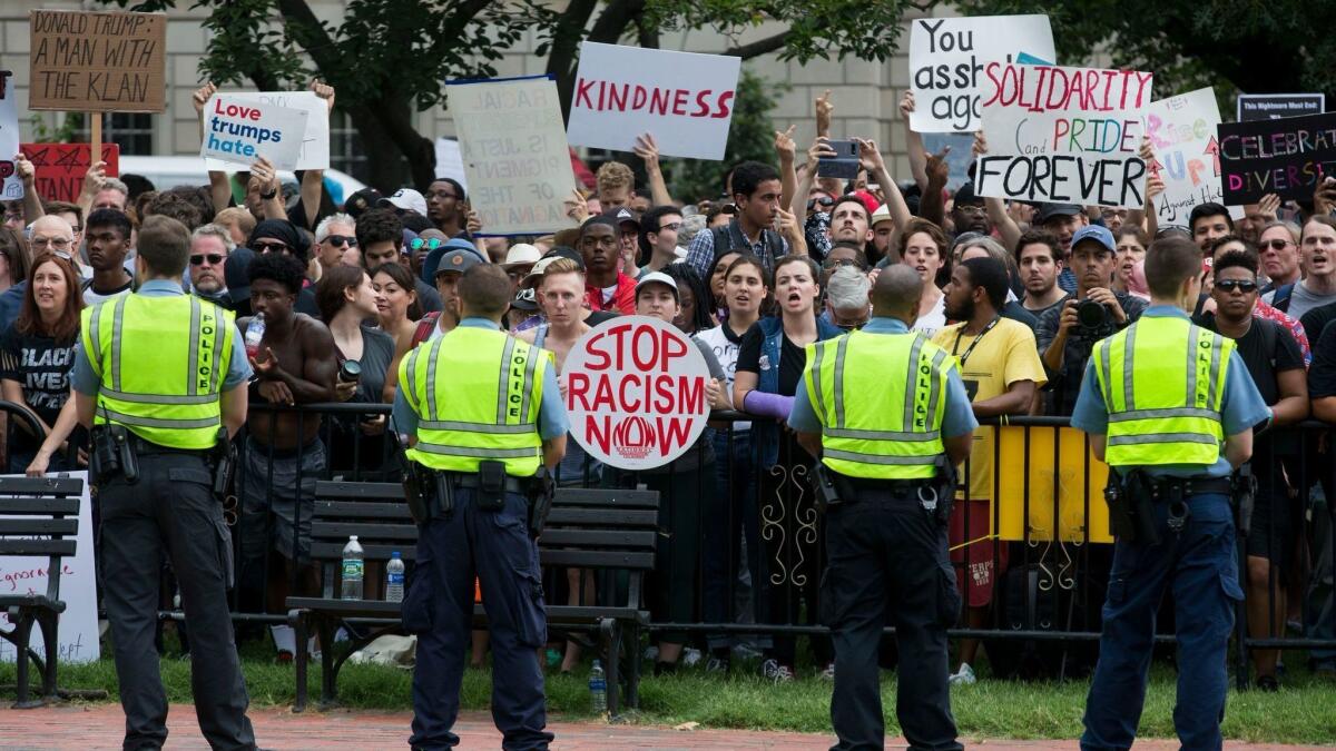 Counterprotesters are seen behind a police line shouting at white supremacists during the 'Unite the Right' rally in Lafayette Park on Aug. 12.