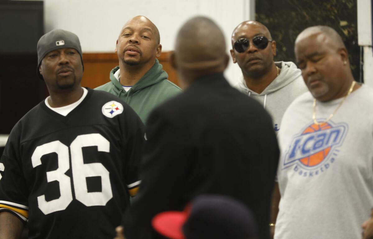 Robinson "G-Nutt" Lonnell, from left, Lamar "Crocodile" Robinson and Kenyan "Kenzo" Payne listen to Marvin Kincy of the Fruit Town Pirus, foreground, as the discussion becomes heated during a gang cease-fire summit in Compton.