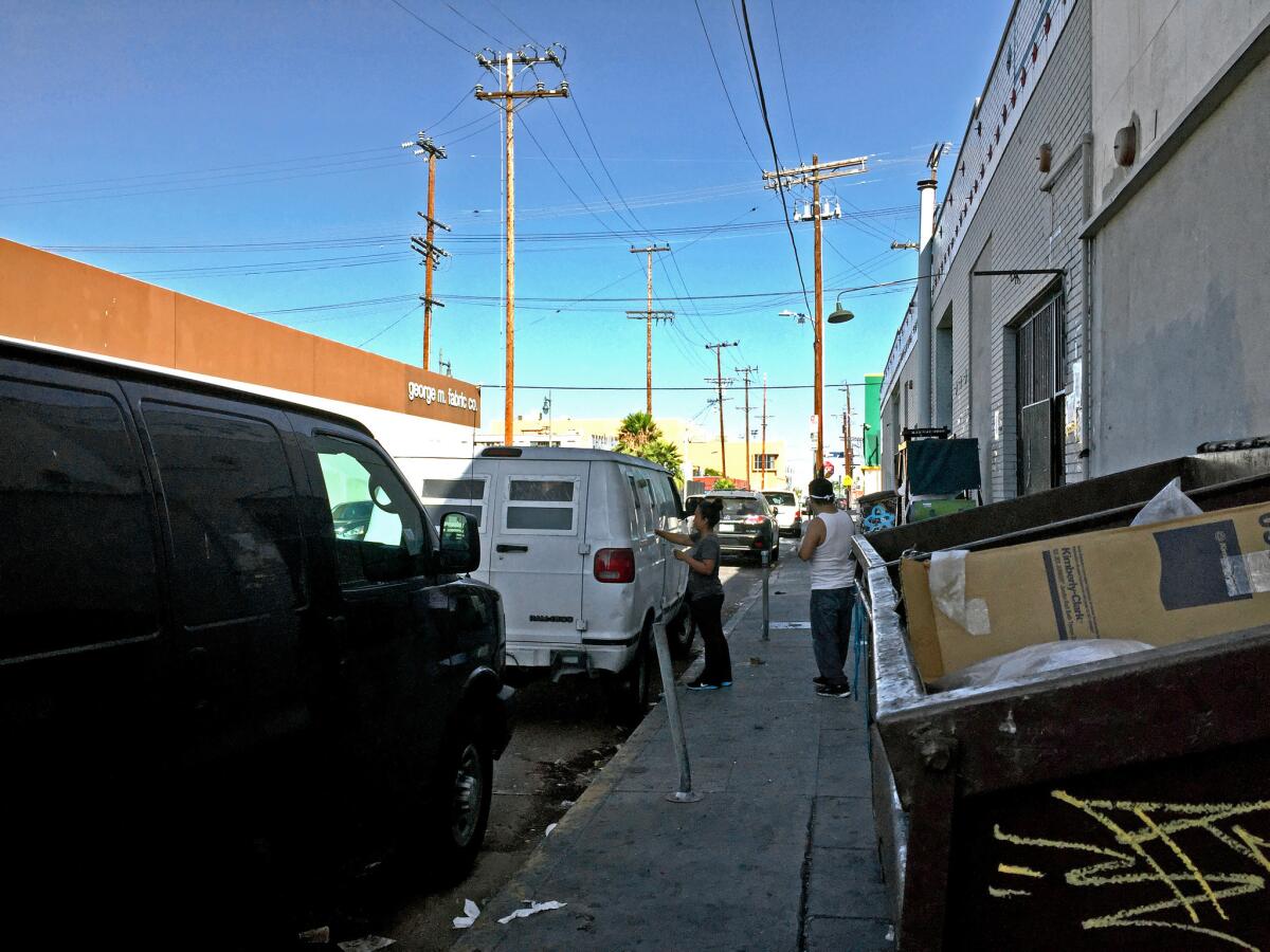 A van parked on 21st street in downtown Los Angeles cashes checks for garment workers and takes a 1% fee.