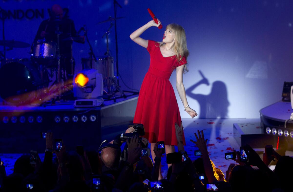 Taylor Swift, shown during an appearance Nov. 6 in London, remains at No. 1 on the nationals sales chart with her "Red" album.