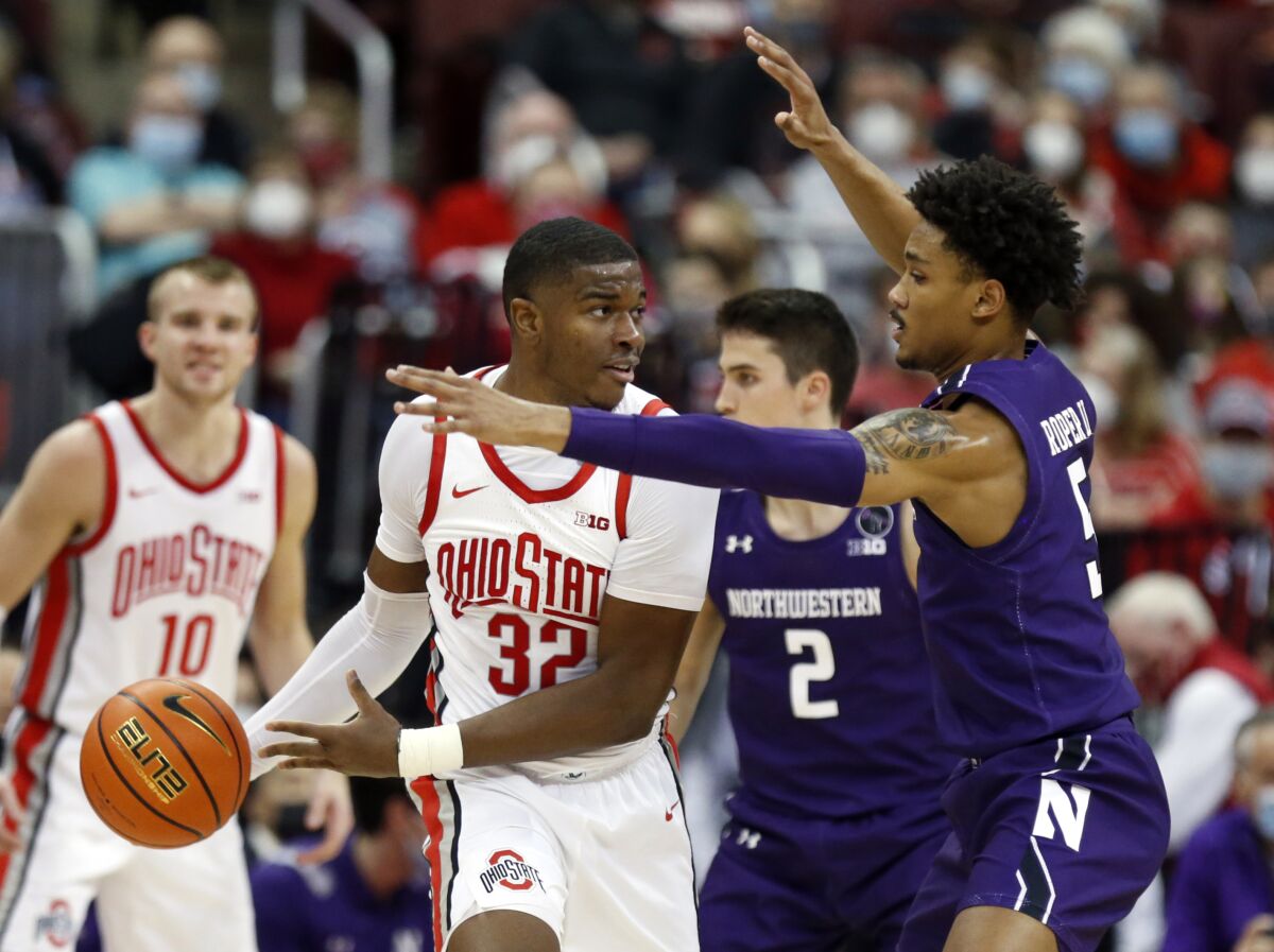 Ohio State forward E.J. Liddell (3) works against Northwestern guard Julian Roper, right, during the first half of an NCAA college basketball game in Columbus, Ohio, Sunday, Jan. 9, 2022. (AP Photo/Paul Vernon)
