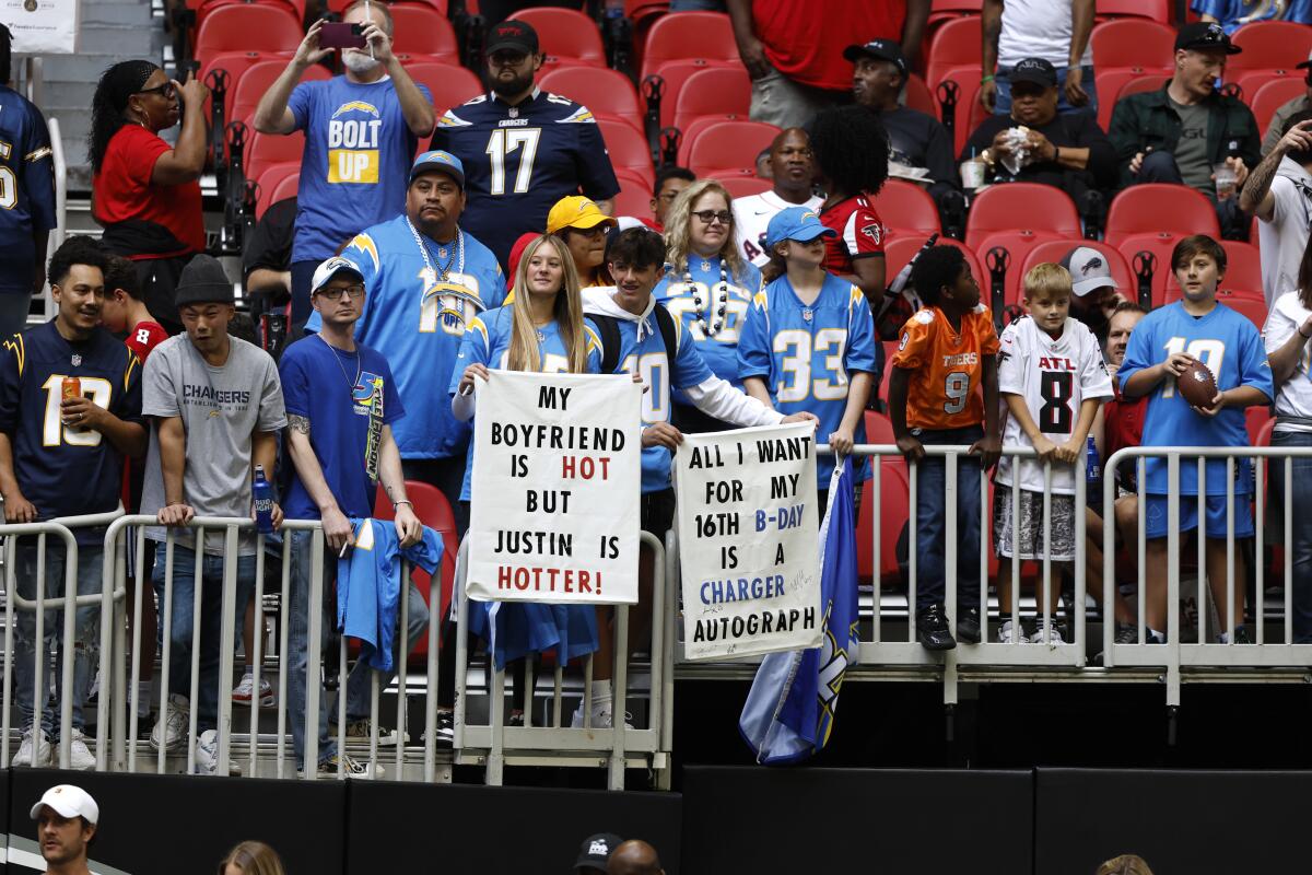 Chargers fans display signs supporting their team against the Atlanta Falcons.