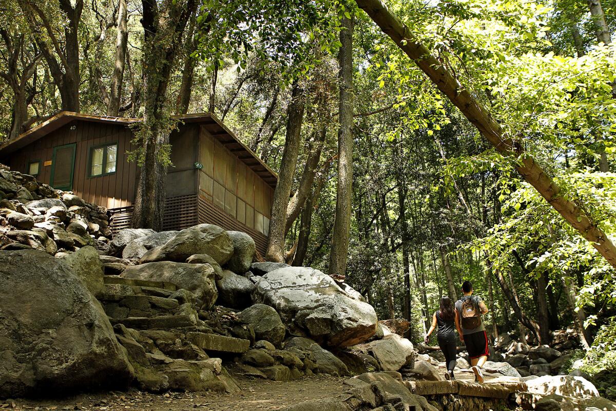 Hikers pass a cabin in the Angeles National Forest.