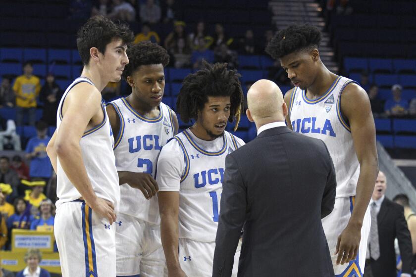 UCLA head coach Mick Cronin talks with Jaime Jaquez Jr., David Singleton, Tyger Campbell and Chris Smith, from left, during a timeout at an NCAA college basketball game against Colorado Thursday, Jan. 30, 2020, in Los Angeles. (AP Photo/Michael Owen Baker)