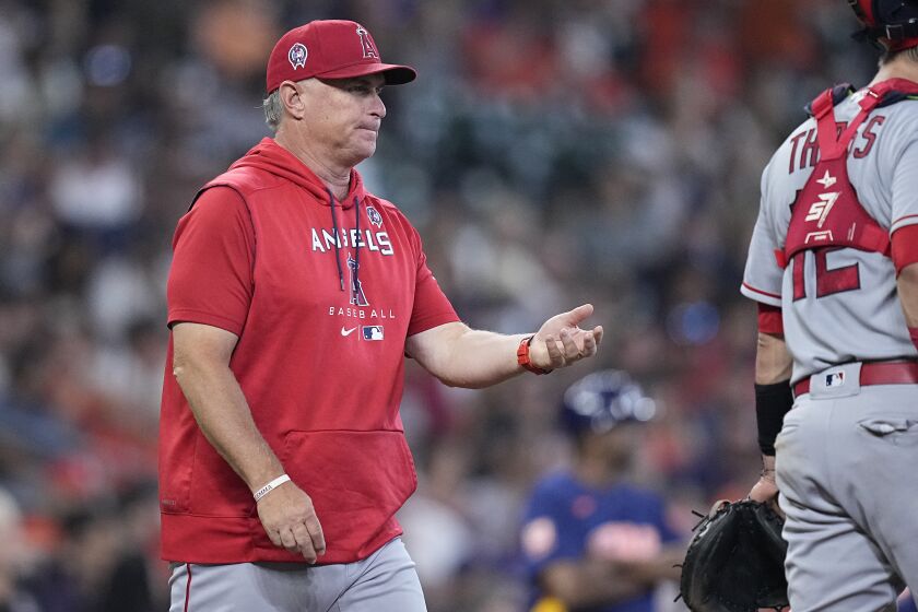 Los Angeles Angels interim manager Phil Nevin walks to the mound to pull starting pitcher Tucker Davidson during the third inning of a baseball game against the Houston Astros, Sunday, Sept. 11, 2022, in Houston. (AP Photo/Kevin M. Cox)