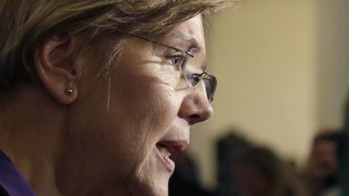 Sen. Elizabeth Warren, D-Mass., speaks to reporters at the Massachusetts Statehouse on Jan. 2.