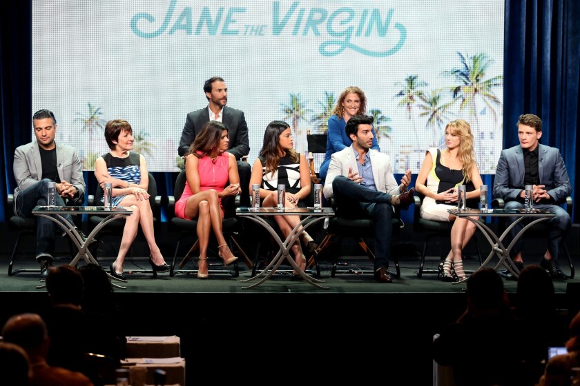 Producers Ben Silverman and Jennie Snyder Urman (top) and actors (front from left) Jaime Camil, Ivonne Coll, Andrea Navedo, Gina Rodriguez, Justin Baldoni, Yael Grobglas and Brett Dier discuss "Jane the Virgin" at the El Rey Network panel of the TCA press tour.