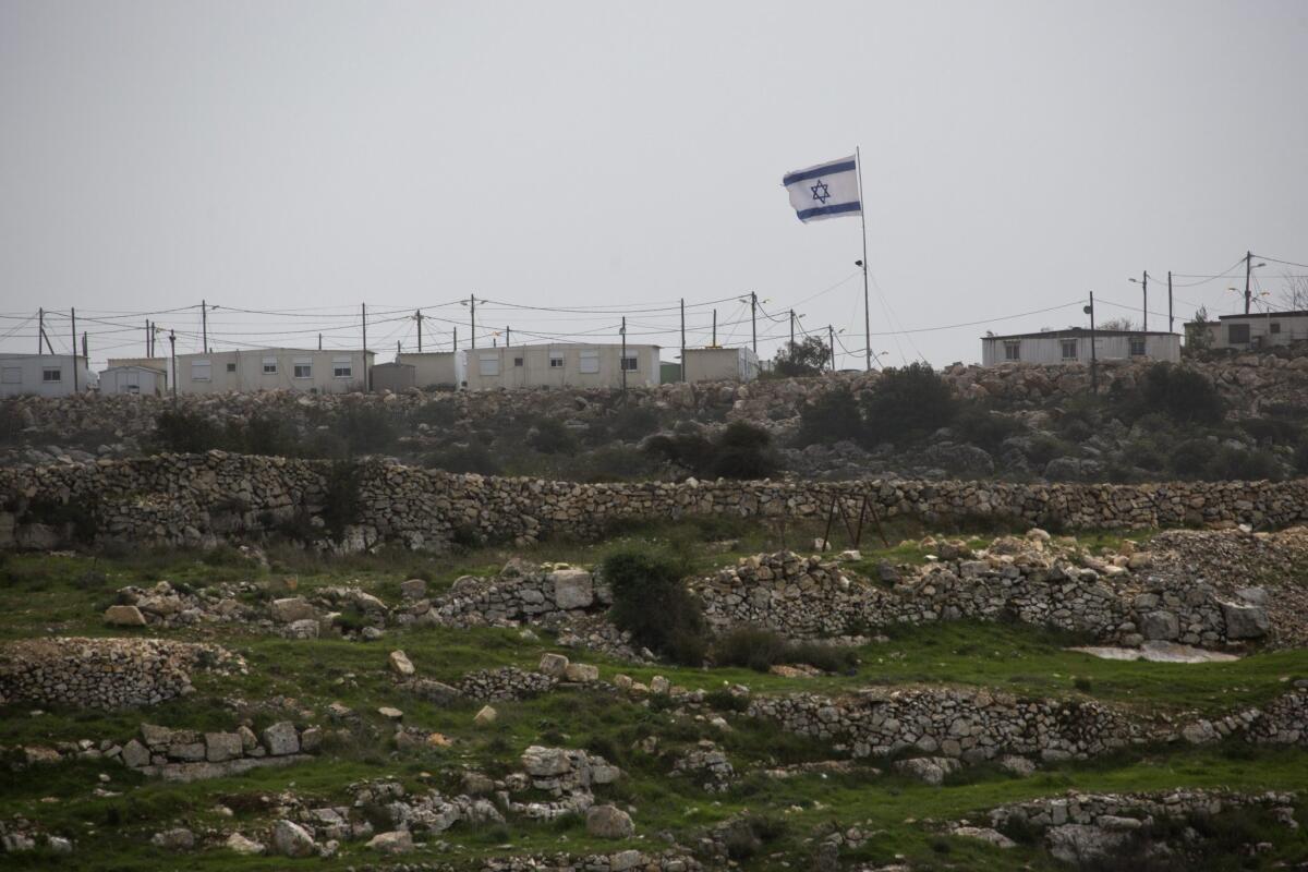 A large Israeli flag flies near a small Jewish settlement of Ha Tamar, just outside the large Efrat settlement in the West Bank.