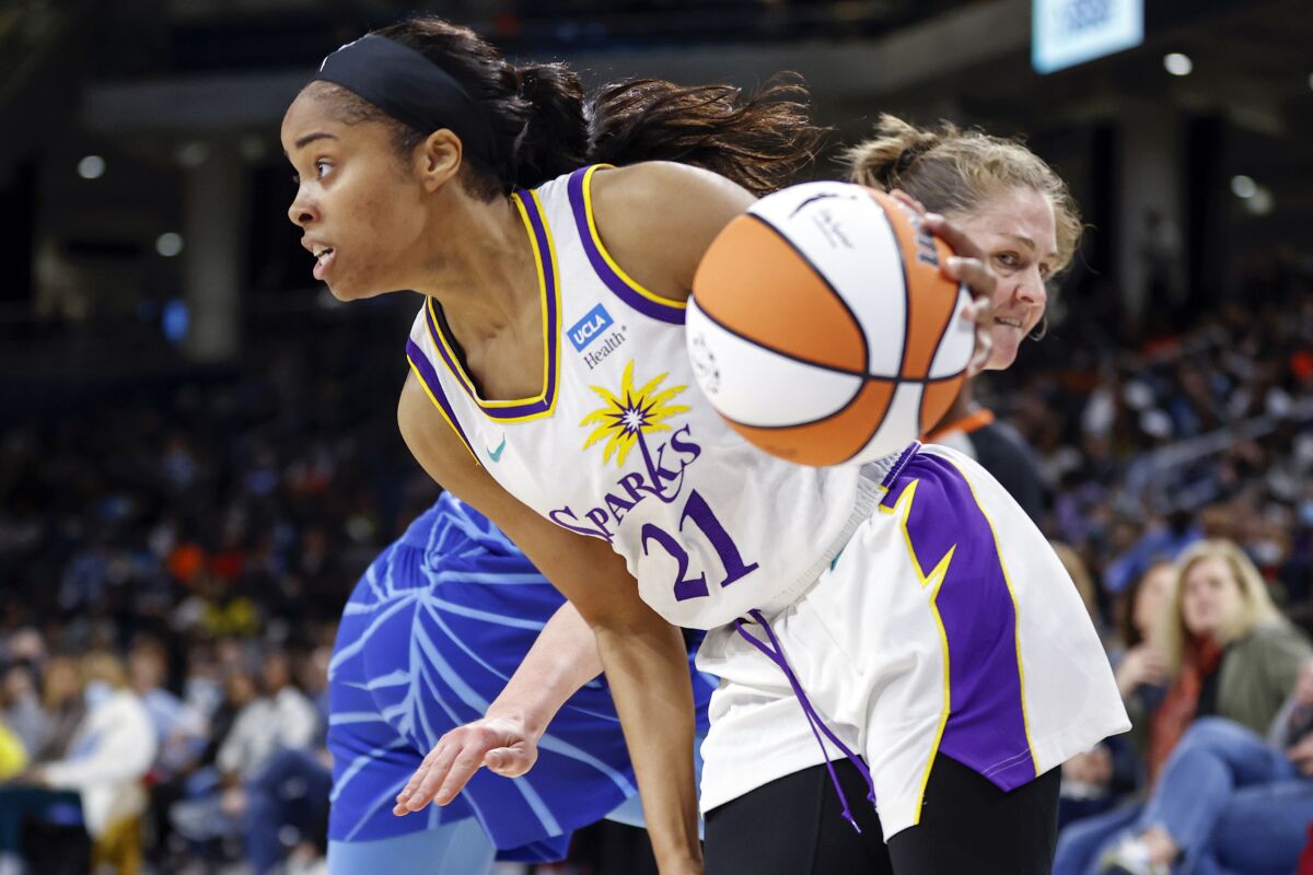 FILE - Los Angeles Sparks guard Jordin Canada drives past a Chicago Sky player during the first half of the WNBA basketball game, on May 6, 2022, in Chicago. Canada is staying with her hometown Los Angeles Sparks. The guard was re-signed to a training camp contract on Wednesday, Feb. 8, 2023. (AP Photo/Kamil Krzaczynski, File)