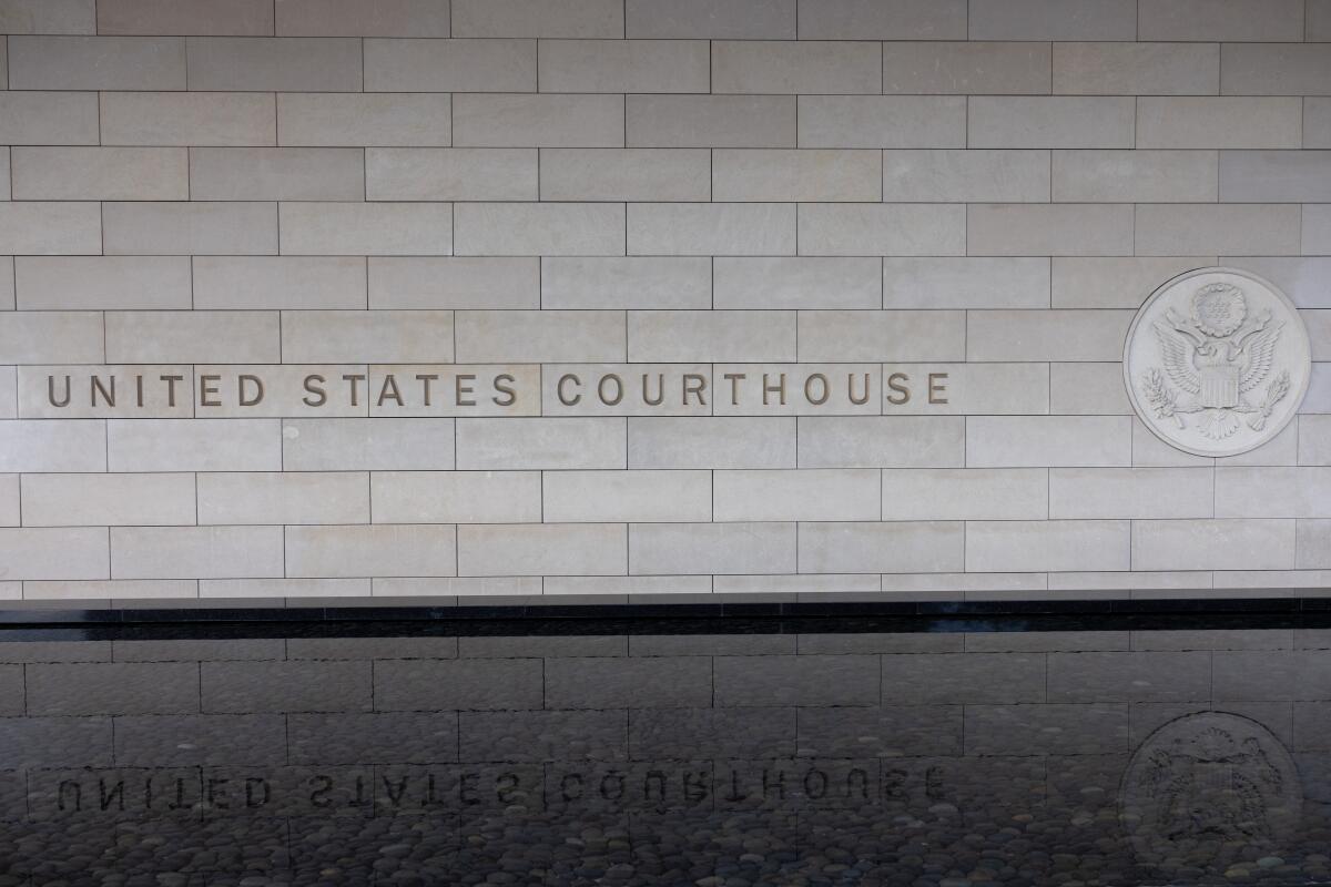 A wall with the words "United States Courthouse."