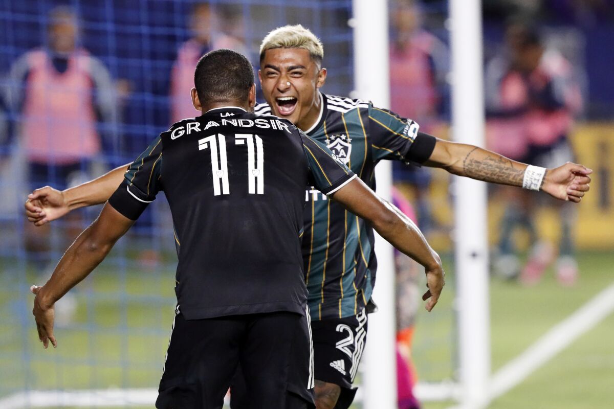 The Galaxy's Julian Araujo, right, celebrates a goal by Samuel Grandsir during the second half July 30, 2021. 