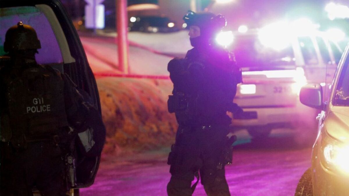 Police survey the scene after a deadly shooting at a mosque in Quebec City, Canada, Sunday, Jan. 29, 2017. Quebec Premier Philippe Couillard termed the act "barbaric violence" and expressed solidarity with victims' families.