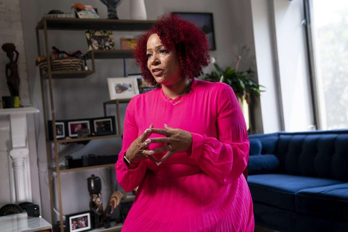 FILE - In this Tuesday, July 6, 2021, file photo, Journalist Nikole Hannah-Jones is interviewed at her home in the Brooklyn borough of New York. Backed by $20 million in donations, Hannah-Jones announced Tuesday that she will establish the Center for Journalism and Democracy at Howard to increase diversity in journalism. Hannah-Jones used major philanthropic donors to build her future as a tenured professor, just as other major donors sought to stymie the Pulitzer Prize-winning Black investigative reporter at the University of North Carolina. (AP Photo/John Minchillo, File)