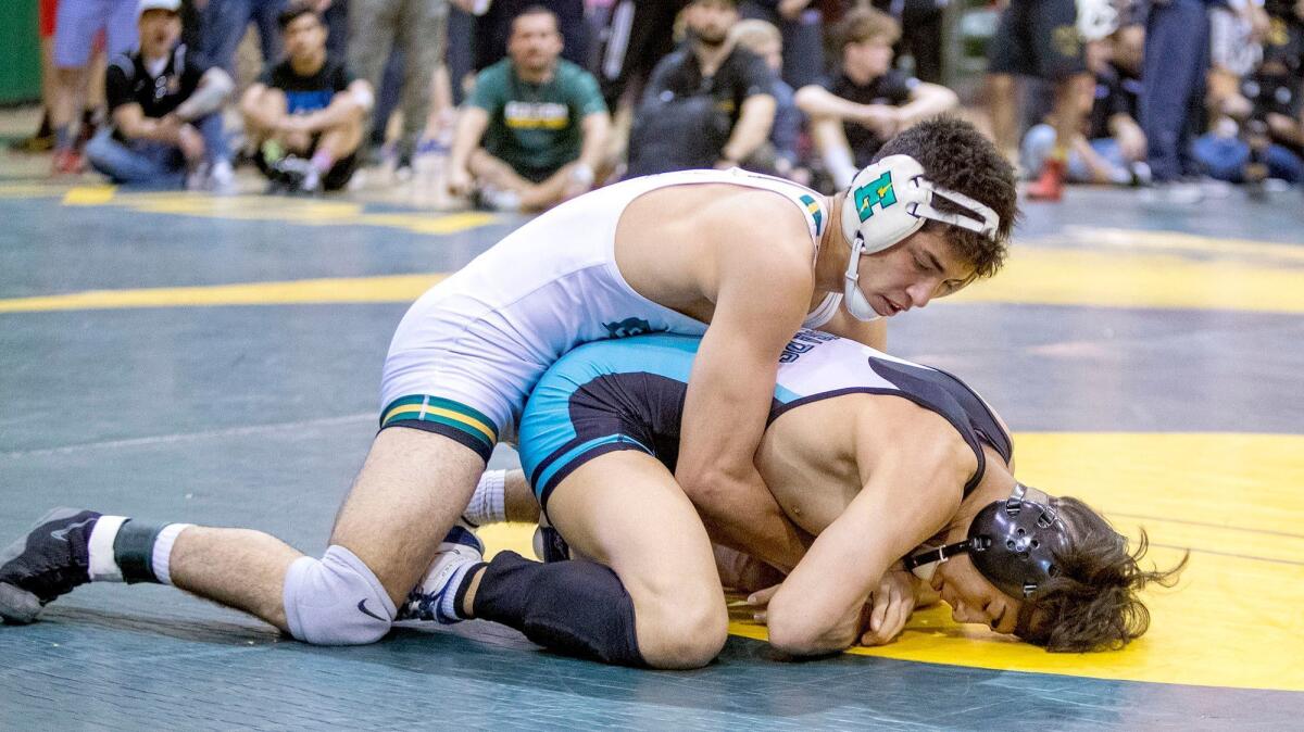 Edison High's Elijah Palacio wrestles Canyon Springs' Aaron Diaz in the 132-pound weight class during the CIF Southern Section Southern Division wrestling championships on Feb. 17, 2018.
