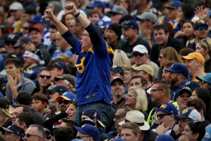 A Rams fan joins a chorus of "boos" as they express their disappointment in the team during the first half of a 42-14 loss to Atlanta.