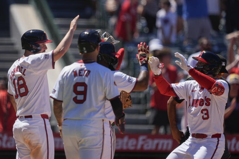 Los Angeles Angels' Taylor Ward (3) celebrates his grand slam with, from left, Nolan Schanuel (18), Zach Neto (9) and Luis Rengifo during the fourth inning of a baseball game against the Oakland Athletics, Sunday, July 28, 2024, in Anaheim, Calif. (AP Photo/Ryan Sun)