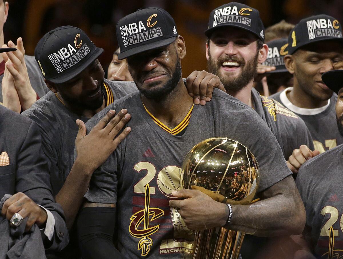 Cavaliers forward LeBron James, center, celebrates with teammates, including Kevin Love, third from left, after winning the NBA Finals against the Golden State Warriors on June 19.