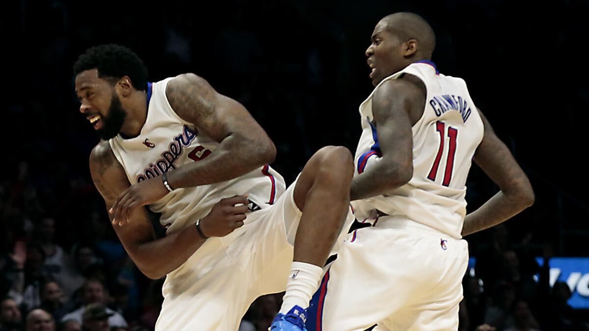 Clippers center DeAndre Jordan, left, celebrates with Jamal Crawford after scoring off a long pass from Crawford against the Denver Nuggets on Jan. 26.