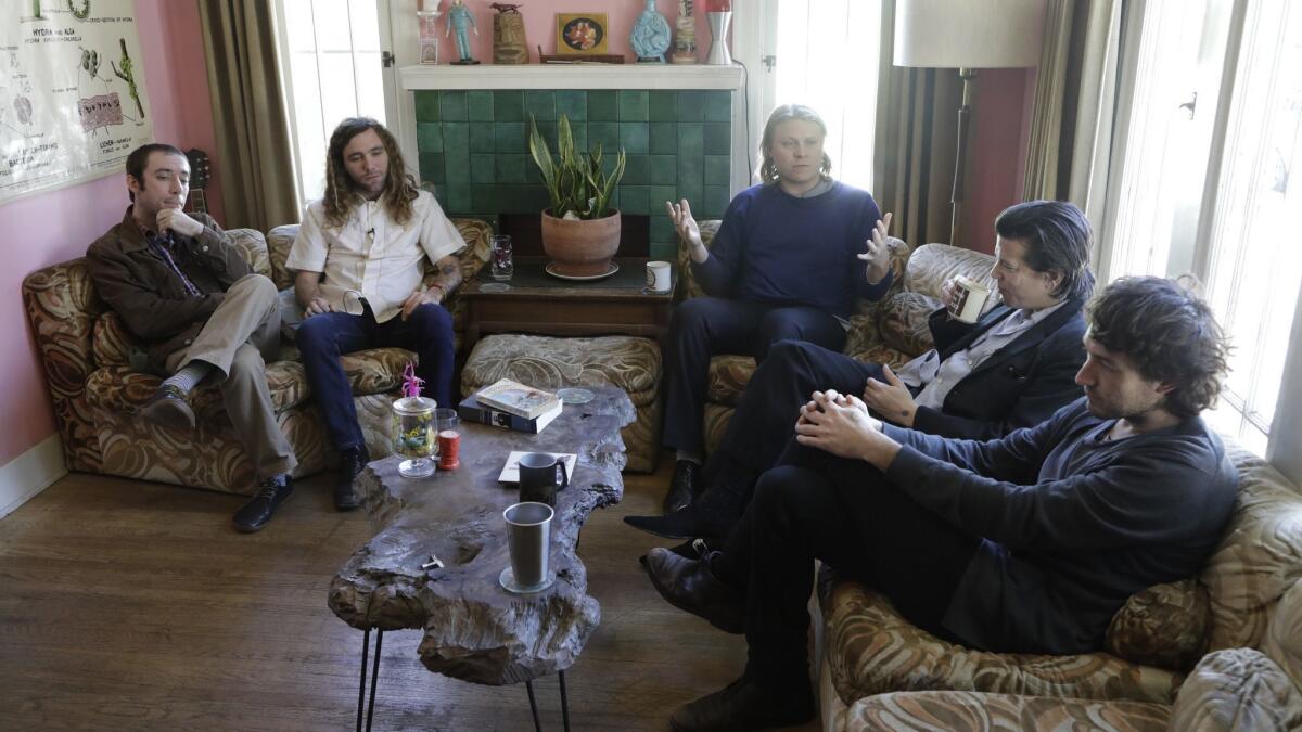 Ty Segall, center, speaks during an interview with his band in Segall's house in Eagle Rock. His band members are Ben Boye, left, Charles Moothart, second from left, Emmett Kelly, second from right, and Mikal Cronin, right.