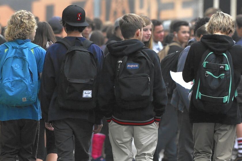 Students attend classes at Huntington Beach High School after being warned that one person on campus was diagnosed with measles earlier this month.