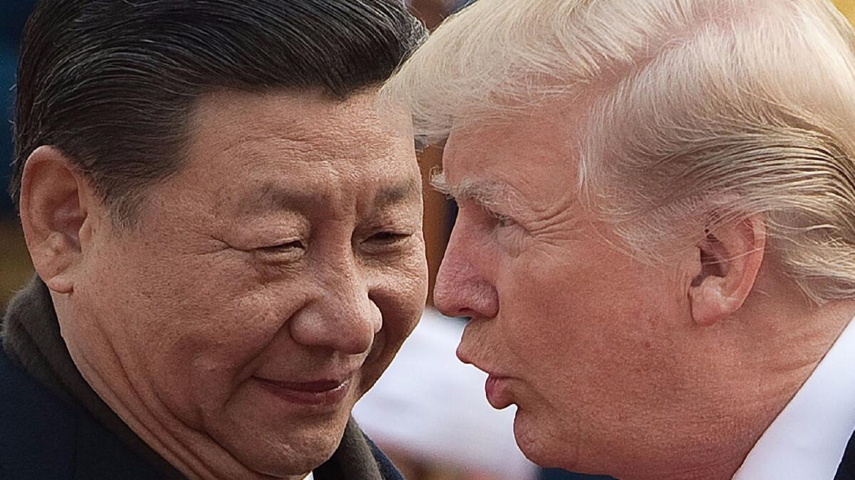 Chinese President Xi Jinping and President Trump attend a welcome ceremony at the Great Hall of the People in Beijing.