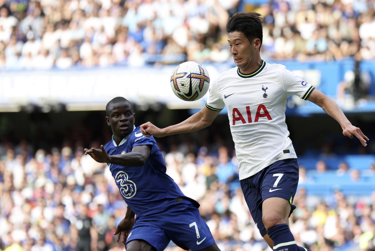 Tottenham's Son Heung-min, right, duels for the ball with Chelsea's N'Golo Kante during the English Premier League soccer match between Chelsea and Tottenham Hotspur at Stamford Bridge Stadium in London, Sunday, Aug. 14, 2022. (AP Photo/Ian Walton)