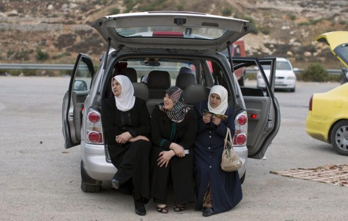 Palestinian women from the West Bank wait near the Israeli military prison of Ofer for inmates to be released.