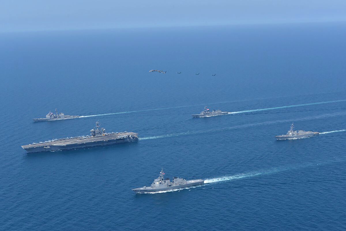 This photo provided by Japan Maritime Self-Defense Force shows USS Abraham Lincoln, left, and JS Kongo, front, sail in formation during a U.S.-Japan bilateral exercise at the Sea of Japan on April 12, 2022. U.S. and Japanese warships, led by the USS Abraham Lincoln carrier strike group, are conducting their joint naval exercise in waters between Japan and the Korean Peninsula for the first time in five yeas, in a show of their close military alliance amid growing speculation of North Korea's missile or nuclear testing later this week.(Japan Maritime Self-Defense Force via AP)