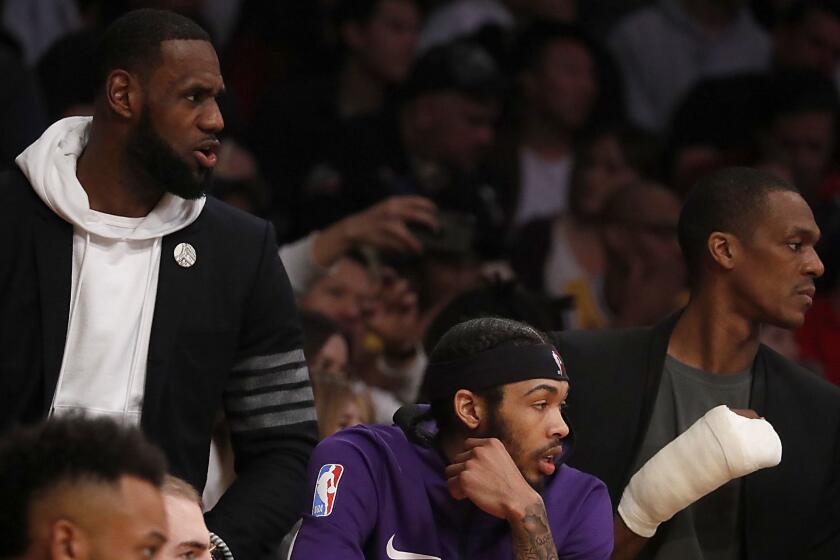 LOS ANGELES, CALIF. - DEC. 28, 2018. Lakers LeBron James, left, Brandon Ingram and Rajon Rondo watch the game against the Clippers from the bench in the second quarter Friday night, Dec. 28, 2018, at Staples Center. (Luis Sinco/Los Angeles Times)
