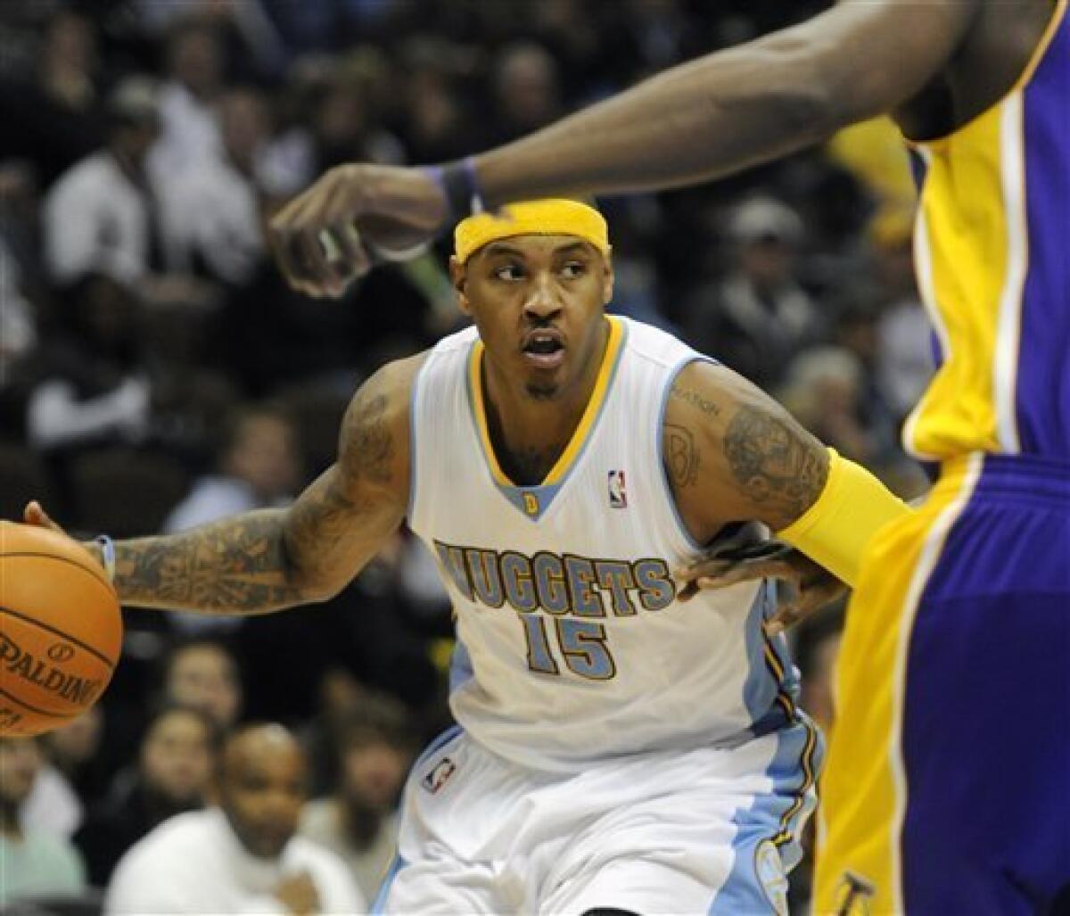 Denver Nuggets' Carmelo Anthony, left, shoots over Los Angeles