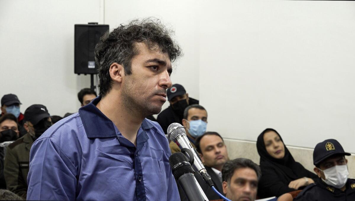Iranian defendant Saleh Mirhashemi in court in front of microphones