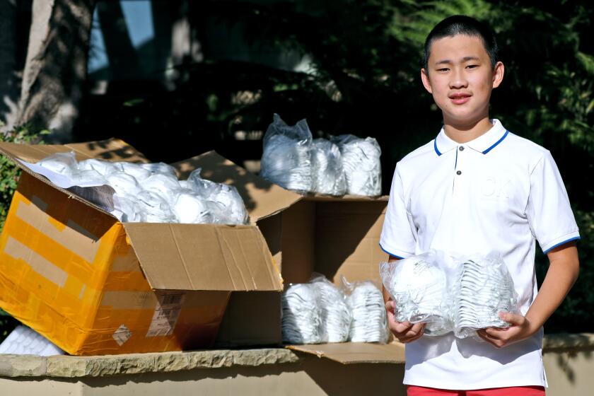 Thirteen-year old Michael Zeng was able to secure 1,000 masks and $5,000 in donations for the Los Angeles Rohingya Association, shown at his home in Newport Beach on Saturday, Oct. 3, 2020.