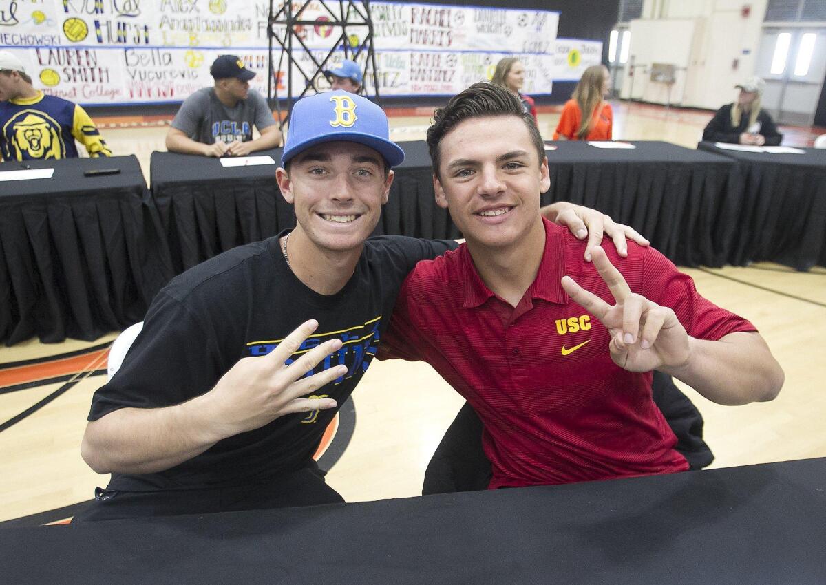 Huntington Beach High student-athletes Hagan Danner, left, and Nick Pratto, attend the National Letters of Intent signing day ceremony in the gym on Feb. 1. Danner will attend UCLA, while Pratto will go to USC to play baseball.