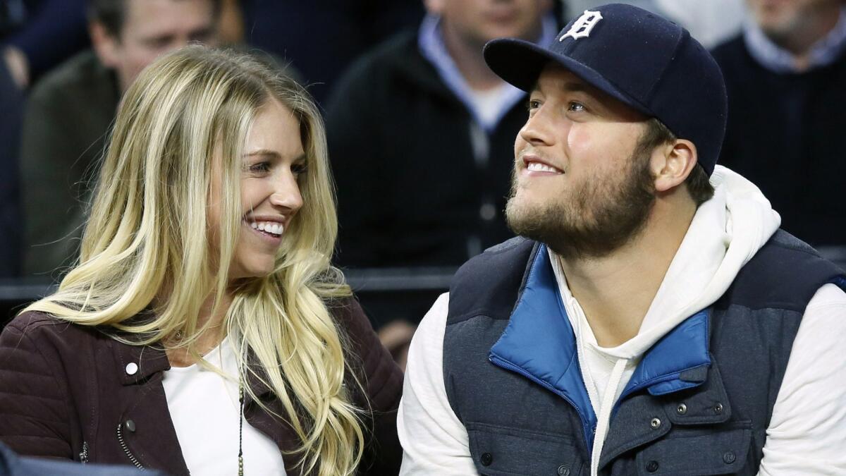 Detroit Lions quarterback Matthew Stafford and his wife, Kelly Stafford, watch the Detroit Pistons play the Cleveland Cavaliers on Nov. 17, 2015.