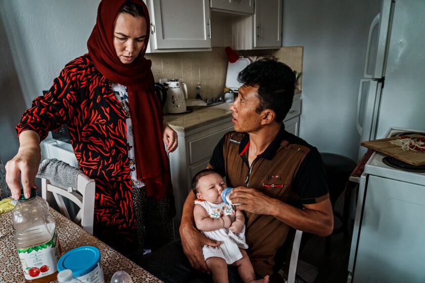 SACRAMENTO, UNITED STATES OF AMERICA -- AUGUST 17, 2022: Ali Zafar Mehran, 36 and his wife Karima Mehran, 31, along with their daughter Sutooda Mehran, 6, and newborn Serena, 1 month old, are Afghan refugees who have resettled in Sacramento, Calif., Wednesday, Aug. 17, 2022. After the U.S. withdrawal from Afghanistan, the Mehran family found themselves building a new life, unable to afford much, sometimes salvaging and refurbishing items that others throw out in the trash. He has to find work to address burgeoning living expenses and has started working delivering food and cleaning a local liquor store. Ali Zafar Mehran has a masters degree in Finance was a budget advisor working alongside Americans in a program supporting the justice sector. He has a Special Immigrant Visa but is awaiting to hear back about the status of his U.S. green card application, as he was in the middle of the interview process before the familyOs chaotic exodus from Afghanistan. For now, he is focused overcoming financial challenges, finding stability for his family and hopes that he finds a better paying job. (MARCUS YAM / LOS ANGELES TIMES)