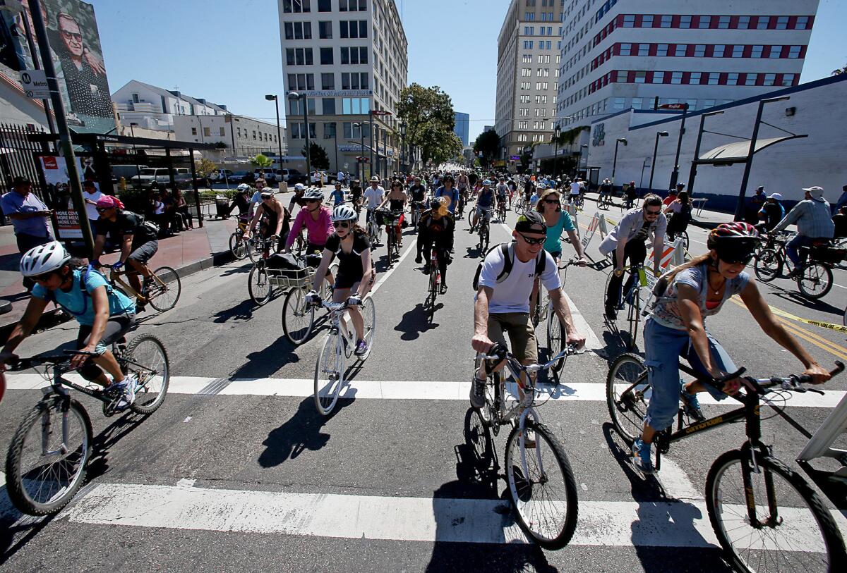 Bicyclists stream through the intersection of Alvarado Street and Wilshire Boulevard in Los Angeles as they participate in the annual CicLAvia bike festival on Sunday.
