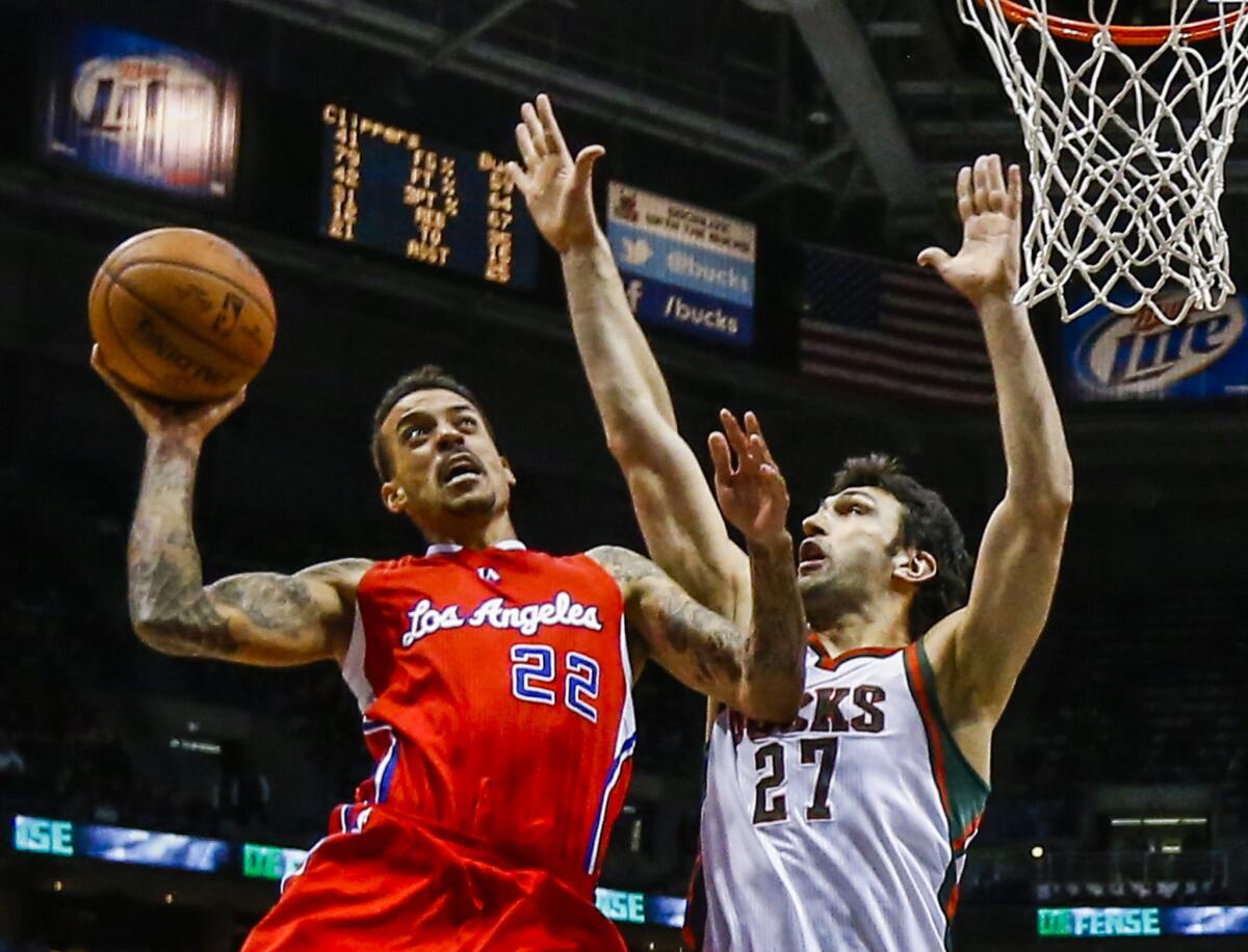 Clippers forward Matt Barnes tries to score inside against Bucks center Zaza Pachulia in the second half.