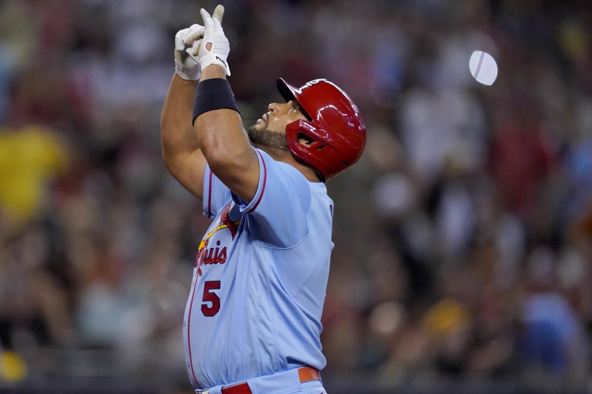 The Cardinals' Albert Pujols points skyward after he hit a solo home run during the fourth inning Aug. 20, 2022.