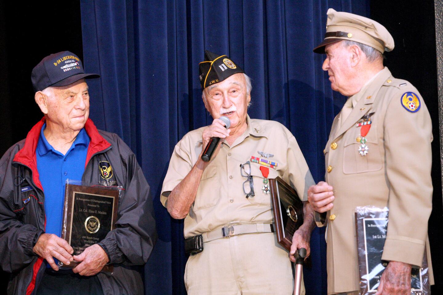 Flanked by World War II heroes Lt. Col. Elmo E. Maiden, 97, left, and Lt. Michael A. La Vere, 90, right, Army Air Corps Cpt. Art Sherman, 94, speaks during Wilson Middle School Veteran's Day assembly at the Glendale school on Tuesday, November 10, 2015. Maiden was a pilot on a B-24 Liberator and flew 35 combat missions from 1944-45. La Vere was a navigator on a B-24 in Europe from 1943-45. Sherman was a bombardier and an intelligence officer in Italy during World War II as well. A special presentation for World War II hero Louis Zamperini was also shown.