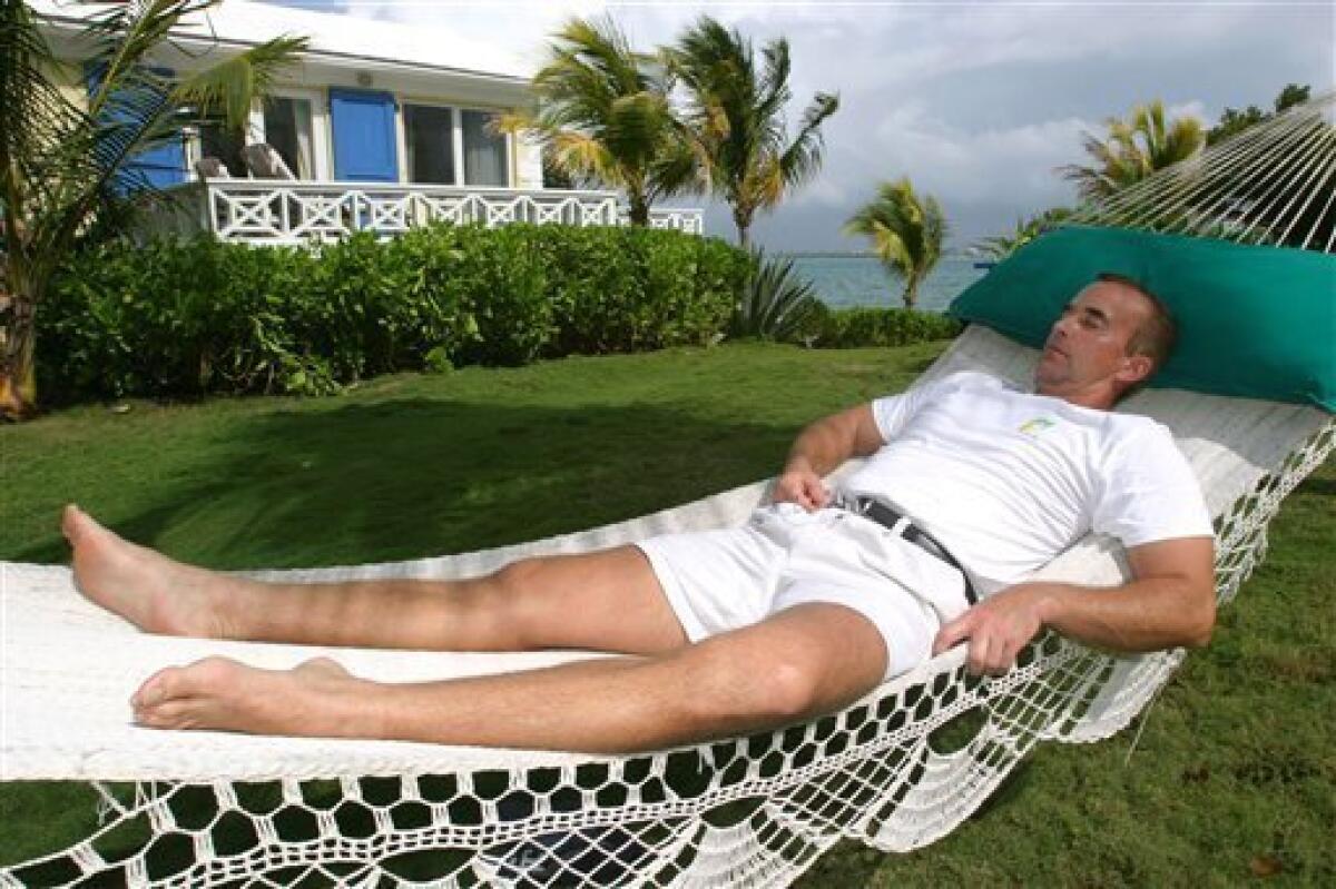 FILE - In this Nov. 4, 2003 file photo, Wallace Tutt naps in a hammock on his private island of Caribe Cay in The Bahamas. The South Florida interior designer whose elegant creations were popular with movie stars, models and fashion icons was found dead on June 12, 2010 in an exclusive area of the Bahamas, according to authorities. (AP Photo/Felipe Major, File)