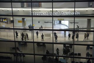 FILE - People in the arrivals area at Heathrow Airport in London, Jan. 26, 2021. The number of people moving to Britain reached a record high of more than 600,000 in 2022, government figures showed Thursday May 25, 2023. (AP Photo/Matt Dunham, File)