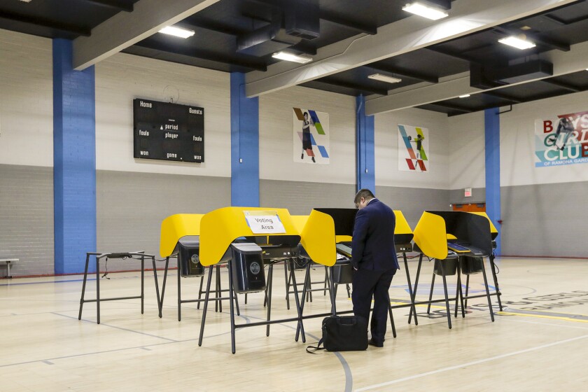 A lone voter casts his ballot at a voting center