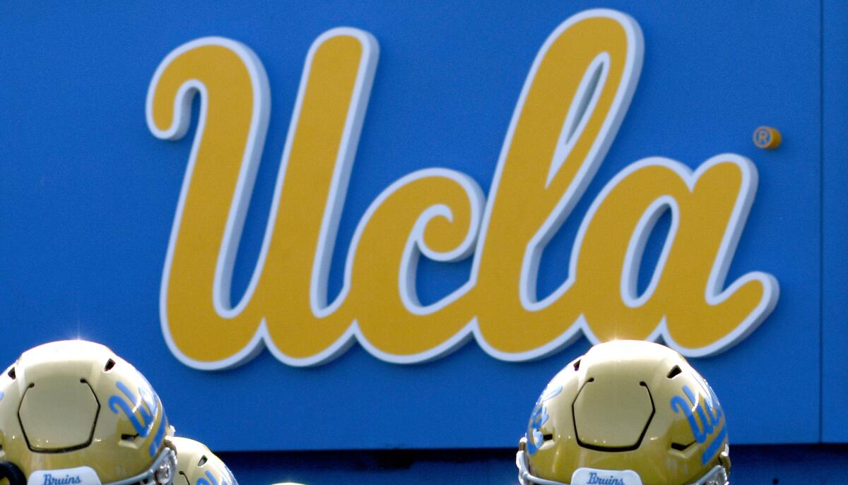 UCLA football players make their way to the field before a game against USC.